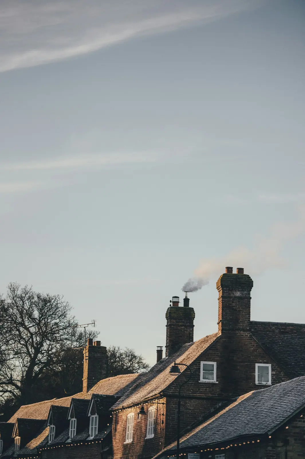 Brick houses with smoke rising from the chimneys