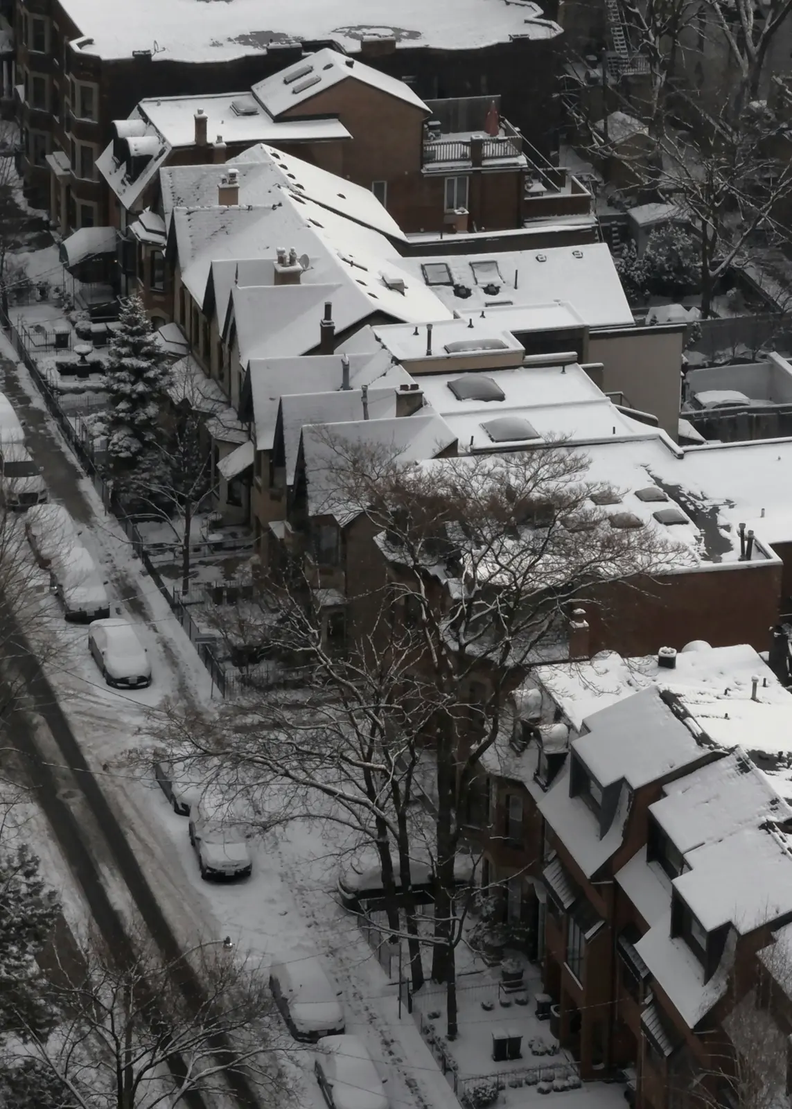 Snow-covered rooftops and streets from above in winter